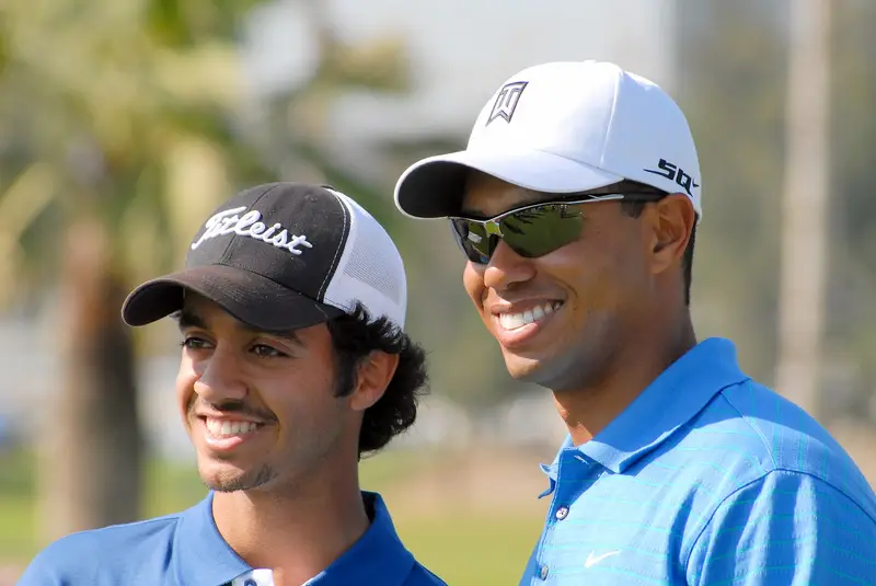 Tiger Woods and Othman Al Mulla smiling at the Dubai Desert Classic