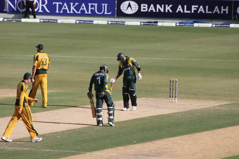 Batters walking out at a cricket match at Dubai Sports City