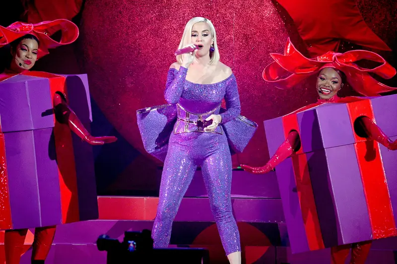 Katy Perry on stage between giant gift boxes