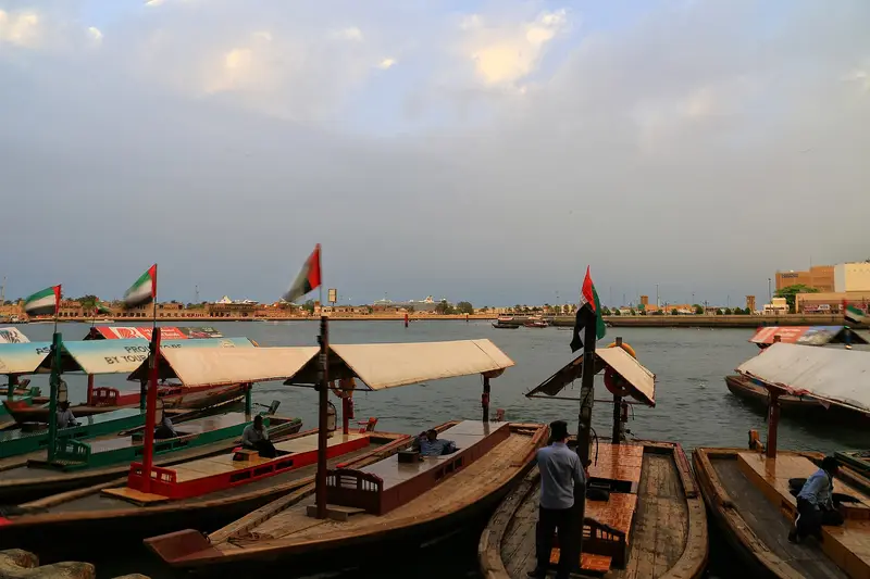 Wooden abra water taxis lined up at a station on Dubai Creek
