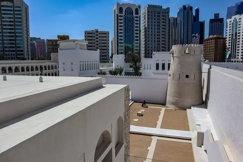The white watchtower of Qasr Al Hosn with the Abu Dhabi skyline behind it