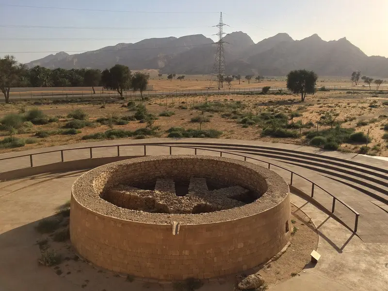 A circular Bronze Age tomb at Mleiha with the Hajar Mountains behind